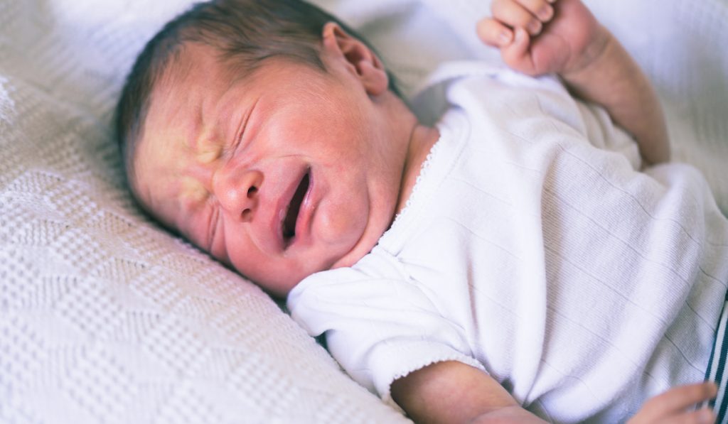 Closeup portrait of crying newborn baby boy