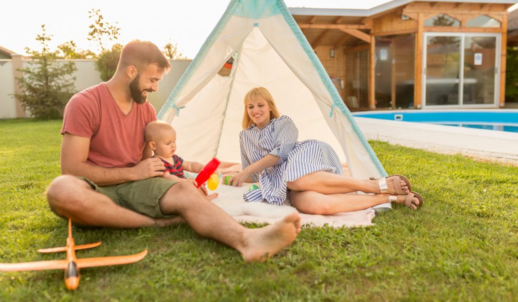 Parents camping in the backyard with their baby boy