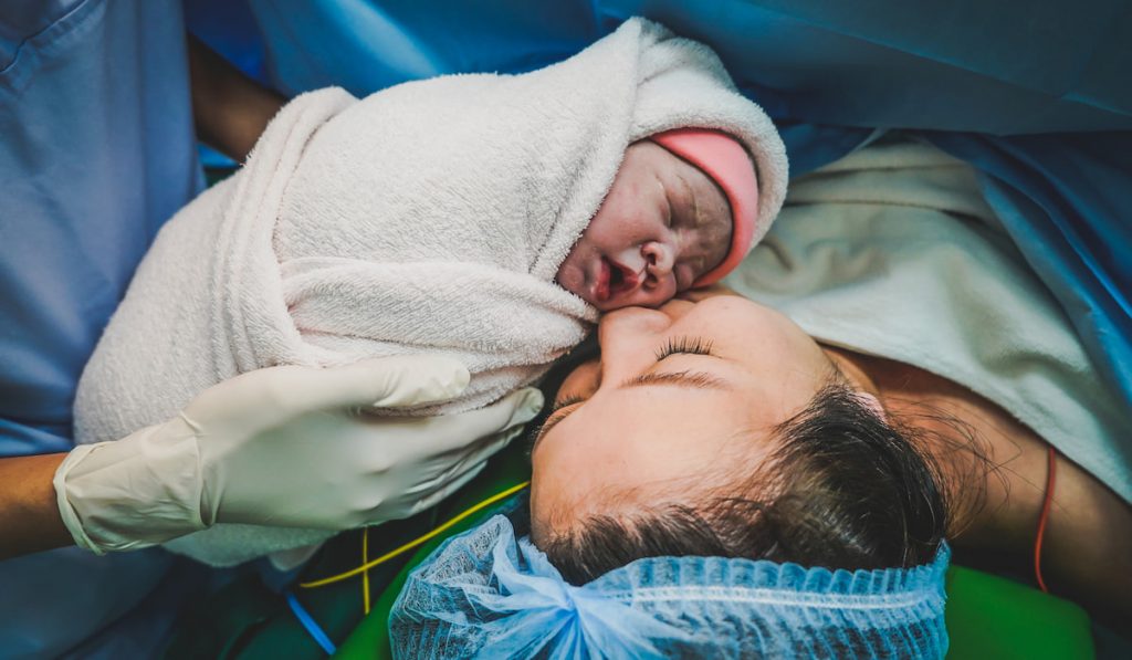 mommy in the caesarian section and her newborn baby