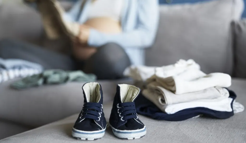 mother getting ready preparing newborn clothes