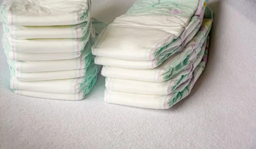 pile of disposable diapers on white table 