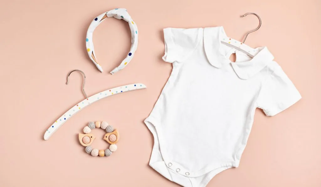 plain white baby bodysuit with headband and hanger
